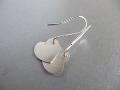 "These earrings are perfect for Valentine's day or any or any gift occasion. I cut the hearts out of sterling silver sheet with my little saw and gave them a soft brushed surface. The ear wires are handmade of sterling silver with a little ball at the end which shows at the front of the heart. Simple, elegant, and sweet. The hearts measure approx. 5/8\" by 5/8\" (16mm by 16mm)" Silver Earrings For Mother's Day Anniversary Gift, Silver Earrings For Anniversary, Mother's Day Gift, Silver Heart Earrings For Anniversary Gift, Silver Heart Earrings For Anniversary, Silver Heart Shaped Earrings For Anniversary, Sterling Silver Earrings For Anniversary, Sterling Silver Earrings For Mother's Day Anniversary, Sterling Silver Earrings For Anniversary And Mother's Day, Sterling Silver Heart Earrings For Anniversary