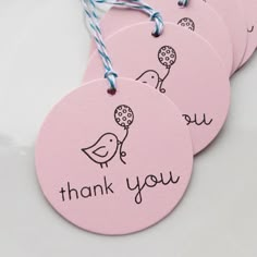 three pink thank tags with birds and balloons on them, hanging from twine string