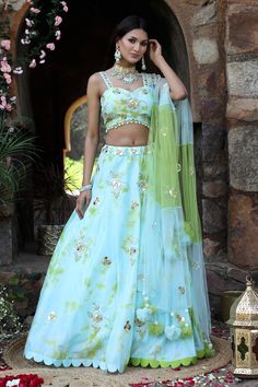 Aqua blue, green attached cancan tie and dye lehenga with floral embroidery detailing. Comes with embroidered padded blouse and dupatta.
Components: 3
Pattern: Dye and Embroidery
Type Of Work: Tie and Dye; Mirror, Nakshi, Beads, Cut-dana, Sequins, Zari Embroidery
Neckline: Sweetheart
Sleeve Type: Sleeveless
Fabric: Uppada Silk, Net
Color: Blue,Green
Other Details: 
Attached lining
Approx Weight: (in kgs) : 4 to 5
Occasion: Mehendi and Haldi - Aza Fashions Designer Green Lehenga With Floral Embroidery, Green Tissue Silk Sets With Floral Embroidery, Green Floral Embroidered Tissue Silk Sets, Green Floral Embroidery Tissue Silk Sets, Festive Green Lehenga With Floral Embroidery, Unstitched Green Organza Lehenga, Green Organza Sharara With Floral Embroidery, Green Lehenga With Floral Embroidery For Navratri, Green Organza Choli With Floral Embroidery