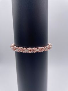 This is a beautifully handcrafted Byzantine Chainmaille Bracelet made with Enameled Copper rings in Rose Gold and Silver colors.  Custom lengths between 5 to 9 inches can be requested by the customer at the time of order.  My standard length is 7 inches.  I can also make it adjustable as well. All sizes are approximate. Delivery time will vary based on the shipping address and time of year. Colors may vary slightly due to different dye lots in the materials and/or your monitor. Elegant Silver-colored Copper Bracelets, Handmade Adjustable Rose Gold Chain Bracelet, Byzantine Style Jubilee Bracelet As Gift, Byzantine Jubilee Bracelet As Gift, Byzantine Pattern, Byzantine Chainmaille, Byzantine Bracelet, Chainmaille Bracelet, Rose Gold And Silver