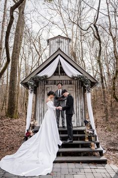 a bride and groom standing in front of a gazebo at their outdoor wedding ceremony