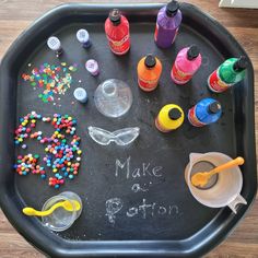 a black tray with lots of crafting supplies and writing on it that says make doton