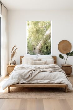 a bedroom with two paintings on the wall and a bed in the foreground,