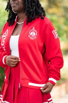 What an adorable way to keep warm while out and about! The Kristi jacket is embroidered with the classics and a Lagniappe (a little extra). The sleeves are customized, with 19 on the left and 13 on the right. Pair this jacket with your favorite light sweater, jeans, or cargo pants; you won't disappoint Sorors. The jacket is a ladies cut. Fitted Track Jacket For College In Fall, Embroidered Fitted Outerwear For College, Ladies Cut, Sweater Jeans, Eastern Star, Delta Sigma Theta, Light Sweater, Out And About, Keep Warm