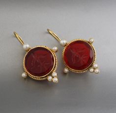 Description Gemstone - Red Glass Material - Brass Gemstone Size - 18 mm Earring Height Including Hoop - 4 cm Earring Width - 2 cm Finish - Smooth and high polished with Little Oxide Antique Look. Note -The earrings are made to order, production day is about 3-5 working days. The one you receive may be slight different from the one in the picture due to handmade nature, but it will be almost same as in the above picture.These pieces are handcrafted from start to finish and have an imperfect handmade look.These earrings are the perfect addition to your collection. Our rings are meant to be classic enough for everyday wear or to give as a bridesmaid gift. You will receive the same piece as in the picture or identical. Since all gemstones are different from each other, I cannot guarantee that Formal Red Pearl Earrings With Matching Set, Red Gemstone Pendant Earrings, Red Oval Wedding Earrings, Handmade Red Round Pearl Earrings, Handmade Red Pearl Earrings, Clip-on Round Crystal Earrings For Gifts, Round Clip-on Jewelry As Gift, Gift Crystal Clip-on Round Earrings, Clip-on Crystal Earrings As Gift