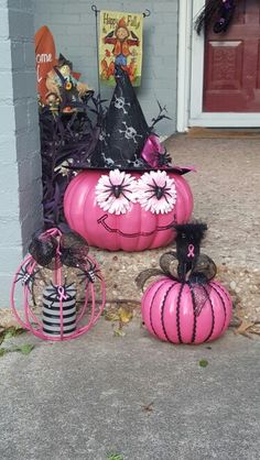 two pink pumpkins decorated with black and white flowers