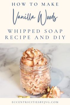 a glass jar filled with whipped soap next to a pile of cashews on a marble counter top