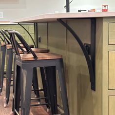 four stools are sitting in front of the counter