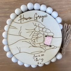 a wooden plaque with a drawing of a hand holding a baby's hand and the words haven grace written on it