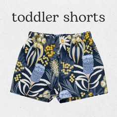 a blue shorts with yellow flowers on it and the words toddlers shorts written in white