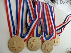 three wooden medals with red, white and blue ribbons