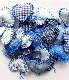 several blue and white fabric flowers on a white surface