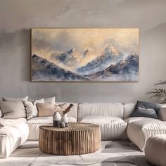 a living room with a large painting on the wall and a white couch in front of it