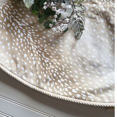 a bouquet of flowers sitting on top of a white and brown table cloth next to a radiator