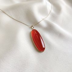 This stunning pendant is set in 14K Solid Yellow Gold with Natural Red Onyx with utmost precision. It is an unique gemstone pendant for nearly every occasion and is completely hassle-free jewelry. 🔷 ABOUT GEMSTONE: Red Onyx is a striking gemstone, celebrated for its deep red hue and smooth, polished surface that radiates strength and vitality. Known for its grounding and protective properties, Red Onyx is believed to enhance stamina, courage, and determination, making it an excellent choice for Elegant Carnelian Necklace With Large Pendant, Oval Carnelian Yellow Gold Jewelry, Elegant Red Gemstones For Gift, Elegant Red Gemstones As A Gift, Elegant Carnelian Gemstones As Gifts, Elegant Carnelian Gemstones As A Gift, Elegant Carnelian Gemstones For Gifts, Elegant Gemstones With Large Stone For Gift, Red Cabochon 14k Gold Jewelry