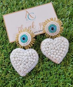 Handmade evil eye earrings, Venezuelan Design in Miami. Unique, not repeated. Super cute for your outfit, you can wear it day or night Size: 3 inches long Material: beads Our earrings are handmade, exclusive to our brand, each model is unique, they are not repeated. We work with excellent materials, natural stones, gold plated, soutache, tassels, crystals, stainless steel and many more of the best quality. Check all the models that we have available in our link www.etsy.com/shop/ACAccessoriesMiami Follow us on instagram @acaccessoriesmiami to find out about everything new we have every day, check all our products, share your photos with our products and be one of our beautiful published clients White Heart Bead Dangle Earrings, White Heart Beads Dangle Earrings, White Dangle Heart Bead Earrings, White Dangle Heart Earrings With Beads, White Heart Beads Drop Earrings, White Drop Earrings With Heart Beads, White Heart Drop Earrings For Party, Trendy White Heart-shaped Earrings, White Heart Charm Dangle Earrings