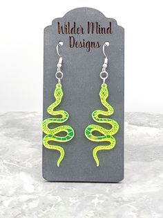 Snake Earrings! They are made from Lime Green Mirror Acrylic- they are lime green mirror on the front with a matte back. These earrings are laser cut, laser engraved and are super lightweight making them easy to wear all day!  *Please Reference Size Guide Picture for sizing* Ear wires are made from surgical stainless steel. Since these earrings are handmade, I highly recommend taking them off for any water related activities such as swimming or showering and while sleeping. They come packed on a Green Dangle Novelty Jewelry, Green Novelty Dangle Jewelry, Green Novelty Dangle Earrings, Green Hypoallergenic Novelty Earrings, Handmade Green Novelty Earrings, Green Handmade Novelty Earrings, Earrings Snake, Snake Lovers, Green Mirror