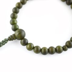 Green Lignum Vitae Wood Juzu Prayer beads Materials : Lignum vitae wood, Silk cord Diameter : about 10cm (not elastic) Head bead : about 16mm Main beads : about 11mm Handmade in Kyoto, JAPAN Lignum vitae wood is said to be the densest wood in the world, grows extremely slowly, and extremely rare, so it is called a "wooden jewel" and is prized.It has the characteristic of changing to a deeper green color over time. It has been treated like a jewel, since ancient times It was only allowed to have by aristocrats. In Japan, Buddhists have Prayer beads (Juzu, Nenju). Kyoto is famous as a producing center of Prayer beads. Prayer beads are a traditional tool used to count the number of times a mantra is recited, breaths while meditating, counting prostrations, or the repetitions of a buddha's nam Buddhist Beads, Lignum Vitae, Kumihimo Bracelets, Traditional Ceramics, Amber Bracelet, Silk Cord, Kyoto Japan, Vintage Japan, Beaded Material