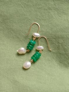 Green onyx and freshwater pearl suspended on earring backs made of tarnish resistant silver-plated copper. Rubber backs are provided. All pieces by Studio Greco are made to order by hand, using natural stones. Because each stone is unique no two pieces will look exactly the same. The precise color, shape, and size of stones cannot be guaranteed. Stones and pearls may contain natural imperfections. For longevity all pieces should be treated delicately and handled with care. Jade Earrings With Ear Wire For May Birthstone, Green Onyx Drop Earrings, Jade Pearl Drop Earrings As Gift, Green Pearl Drop Earrings As Gift, Green Pearl Drop Jewelry As Gift, Green Pearl Drop Earrings For Gift, Green Pearl Drop Jewelry For Gifts, May Birthstone Pearl Drop Dangle Jewelry, Green Jade Earrings For May Birthstone