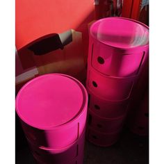 several pink plastic containers stacked on top of each other