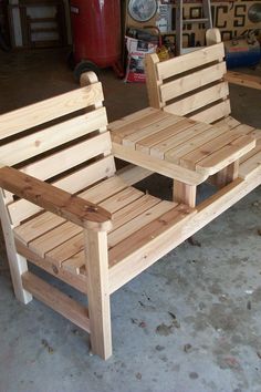 two wooden benches sitting next to each other in a garage with tools on the floor