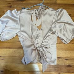 Cream Colored Blouse. Silk. Never Worn. Tag Still On. Open Back With 2 Ties. Size Medium. Abercrombie And Fitch Feminine V-neck Tie Back Tops, Beige Puff Sleeve Top For Party, Beige Short Sleeve Party Top, Spring Night Out Tops With Tie Neck, Spring Night Out Top With Tie Neck, Spring Tie Neck Top For Night Out, Fitted Puff Sleeve Top With Tie Back, Spring V-neck Blouse With Tie Back, Fitted Tie Neck Top For Day Out