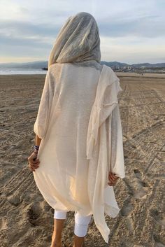 Ivory 100% Cotton Hooded Cloak. Great as a Festival or a Ceremony Clothing. This amazing long soft knit kimono with the hood is handmade from a high quality cotton knits fabric. Please note, we work with upcycled fabrics and sometimes we ran out of the particular knits and we are replacing them with the similar knit fab Mens Kimono Shirt, Nomad Fashion, Hooded Shawl, Moda Kimono, Knit Kimono, Samurai Pants, Festival Clothes, Festival Costume, Black Harem Pants