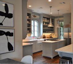 a kitchen with an island and lots of plates on the wall