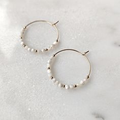 Elegant and minimalist Mother of Pearl hoop earrings! Pictures just do not do these gorgeous earrings justice. These gemstones have the most milky white color with stunning iridescence to them. When they are in the light, you can really see how dynamic they are. These are earrings you will want to wear over and over again. They are neutral enough for everyday wear. And they are the perfect earrings for your wedding day. They also have a coastal look to them, which makes them perfect for your bea Earrings Pictures, Mini Hoop Earrings, Pearl Hoop Earrings, Milky White, Gorgeous Earrings, Earring Necklace, Mother Of Pearl, White Color, Necklaces Bracelets