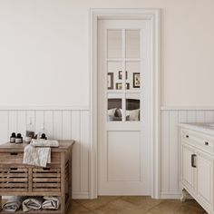 a white bathroom with two sinks and a wooden crate on the floor next to it