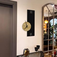 a large clock mounted to the side of a wall in a living room next to a doorway