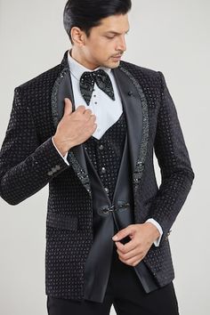 Black tuxedo featuring thread, sequin embroidery in geometric pattern. Paired with a waistcoat, white shirt, black pant and a bow. - Aza Fashions Designer Black Sets For Winter, Traditional Black Blazer For Groom, Festive Black Blazer For Groom, Designer Festive Suit For Winter, Designer Festive Winter Suit, Winter Black Sherwani For Groom, Black Winter Sherwani For Groom, Black Festive Tuxedo Suit, Black Winter Sherwani For Grooms