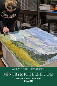 a woman is working on an art piece in her studio with the title wheatfields and cypresses