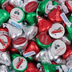 a pile of assorted candy hearts with christmas stickers on them