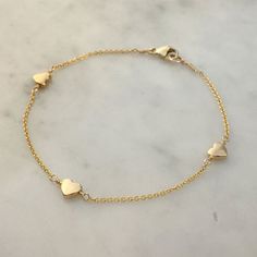 Dainty, easy to wear, understated.  You may order this item in one of 2 colours.  The gold option is made with deep gold plated heart beads and hung from a super-fine goldfilled trace chain, the silver bracelet is solid sterling silver.Deep gold plated heart bead (5%), goldfilled chain and clasp.  Please note I use really high quality materials, the chain and clasp on this bracelet are guaranteed by my supplier to last 30 years.  The charms are very heavy gold plated, so again they will last a v Golden Bracelet, Gold Heart Bracelet, Silver Heart Bracelet, Gold Armband, Jewelry Accessories Ideas, Rose Gold Heart, Tiny Heart, Fancy Jewelry, Girly Jewelry