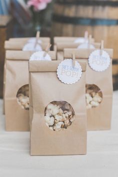 small brown bags filled with popcorn sitting on top of a table