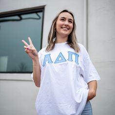 This trendy & unique Basic Minimalistic Sorority Comfort Colors Crew Neck Greek Letter Shirt is sure to stand out on any campus! Grab one for you, your big/little, or a group of sisters Picture Details ⭑ #1-2: White Shirt, Light Blue top fabric, Royal Blue thread color ⭑ #3: White Shirt, Light Purple top fabric, Purple thread color Care Instructions ⭑ Wash inside out on cold & air dry for best results ⭑ Do not dry clean ⭑ Light iron if necessary ⭑ Care instructions are included with every order. Spring Cotton Varsity T-shirt, Varsity Tops For College In Spring, Varsity Tops For College Spring Season, Spring Varsity Tops For College, White School Spirit Top For Spring, Spring College Style T-shirt, Varsity Cotton Tops For School, White Varsity Tops For School, White Collegiate Tops For School