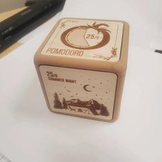 a wooden dice with the words pomodoro on it sitting on top of a desk