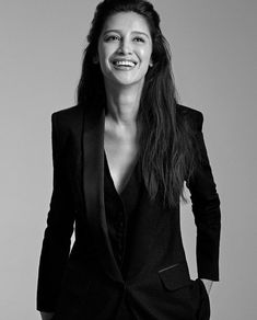 a black and white photo of a woman in a suit