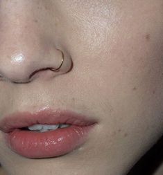 a woman's nose with an ear piercing