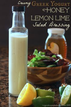 a bottle of lemon lime salad dressing next to a bowl of vegetables and a jar of yogurt