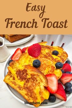 french toast with strawberries and blueberries on top