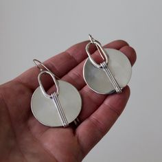 I handcraft these Circle with Lines earrings from sterling silver and add a shiny finish or Shiny with a hand textured accent. Please let me know in notes at checkout if you prefer them with hand texture Measures: @1.25" width Material: Silver (.925). All materials are hypoallergenic. These Earrings are designed and handcrafted in my studio in Concord, NH Circle With Lines, Concord Nh, Fall Shows, Contemporary Earrings, Phone Ring, Silver 925, Silver Earrings, Let Me, Drop Earrings