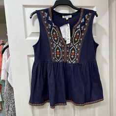 New With Tag. Size M Boho Embroidered Navy Blue Blouse Super Cute Similar To Free People Or Madewell Styles Embroidered Cotton Sleeveless Tank Top, Sleeveless Cotton Embroidered Beach Top, Sleeveless Embroidered Cotton Top For Beach, Vacation Sleeveless Tops With Floral Embroidery, Bohemian Sleeveless Top With Floral Embroidery, Blue Embroidered Sleeveless Blouse, Sleeveless Tops With Floral Embroidery For Vacation, Blue Sleeveless Embroidered Blouse, Casual Sleeveless Embroidered Top For Vacation