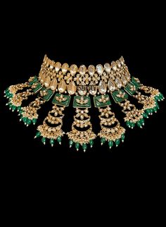 Tiana I - Indian Bridal Set w/ Emerald Drops, Kundan & Green Meenakari work Stunning modern choker necklace for Indian brides with Kundan stone setting. Fit for any fashionista who appreciates the beauty of fine craftsmanship and design all in one stunning set! Stunning green Meenakari work adorns this bridal set in square-shaped metal detail. This set is elaborated with moon design detailing of Kundan gems. This classic bridal jewelry is further accented with mini green emerald stone drops at t Luxury Kundan Jewelry With Stone Work, Luxury Kundan Bridal Necklace With Stone Work, Luxury Meenakari Jewelry For Wedding, Luxury Stone Work Jewelry For Festive Season, Luxury Kundan Chandbali Jewelry, Luxury Kundan Wedding Necklace With Stone Work, Luxury Kundan Necklace With Stone Work For Wedding, Luxury Stone Work Jewelry Sets For Festive Occasion, Temple Jewelry Style Choker Necklace For Receptions