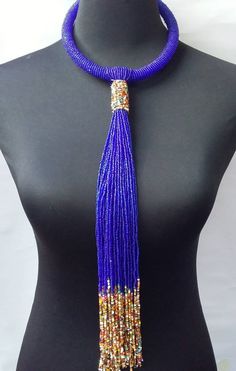 African beaded necklace made with the royal blue beads. Its a perfect accessory that will match most of your outfits. Suitable for any season. A good gift to your friends and loved ones. Elegant Blue Large Beads, Elegant Blue Beaded Necklaces With Large Beads, Elegant Large Blue Beads, Elegant Blue Beaded Necklace With Large Beads, Blue Tassel Necklace For Gift, Elegant Blue Dangling Beads, Elegant Blue Beads For Party, Blue Tassel Necklace, Elegant Blue Party Beads