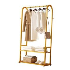 an ironing rack with clothes hanging on it