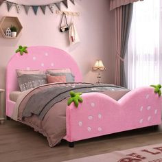 a bedroom with pink furniture and decorations on the walls