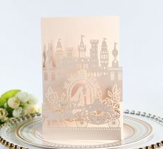 a wedding card with a silhouette of a bride and groom in the background on a plate