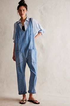 One-and-done and so simple, this denim jumpsuit from our We The Free Collection is featured in a relaxed fit and cropped ankle-length style with harem legs and a low scoop neckline. **Fit:** Slouchy, relaxed fit; ankle-length, pull-on style **Features:** Denim fabrication, rigid feel, low scoop neckline, seam detail throughout, oversized patch pockets, drop-crotch harem-style legs, low back with adjustable shoulder straps **Why We | We The Free High Roller Jumpsuit at Free People in Light Wash, Cheap Relaxed Fit Denim Jumpsuit, Denim Jumpsuits, High Roller, Square Neck Top, Strapless Mini Dress, Denim Jumpsuit, Amelie, Dress With Bow, Low Back